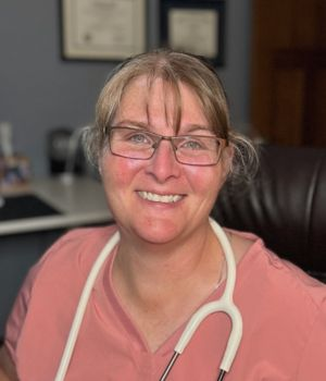 Jody Buchanan WHNP headshot with stethoscope smiling